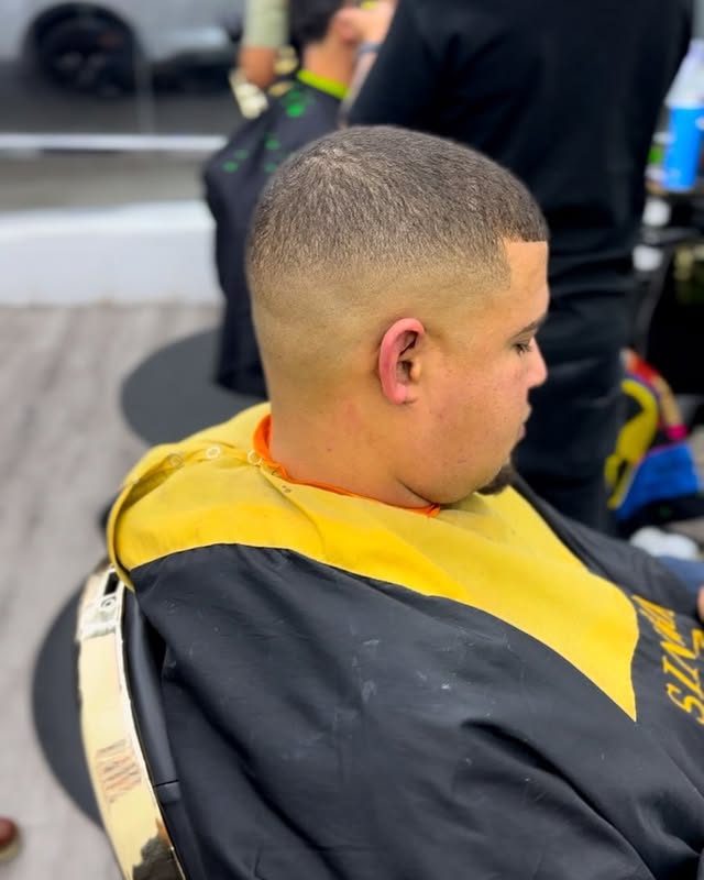Client in the chair at Adelbi's Barbershop, Bronx