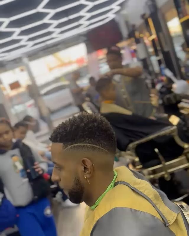 Inside Adelbi's Barbershop, Bronx — modern interior with honeycomb LED ceiling