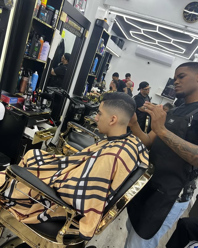 Barbers at work inside Adelbi's Barbershop, Bronx NYC